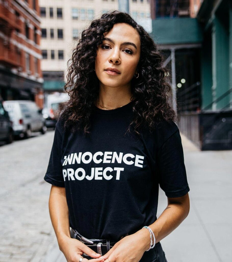 A woman wearing a black Innocence Project shirt